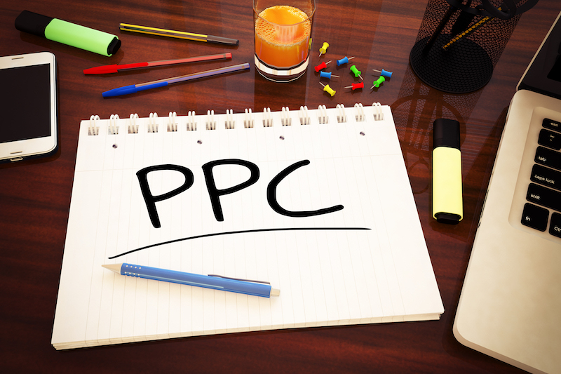 PPC - Pay per Click - handwritten text in a notebook on a desk - 3d render illustration.